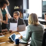 A group of people sitting around a table.