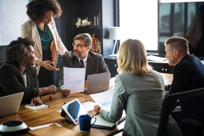 A group of people sitting around a table.