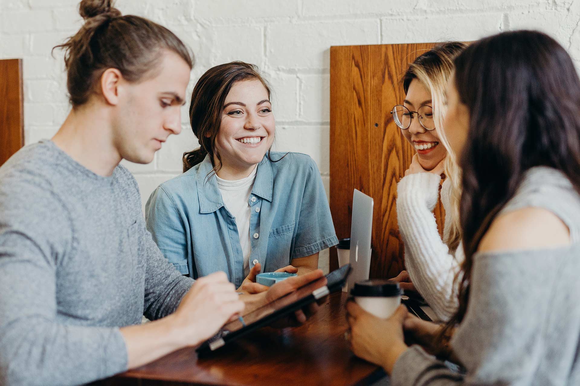 A group of people sitting around a table.