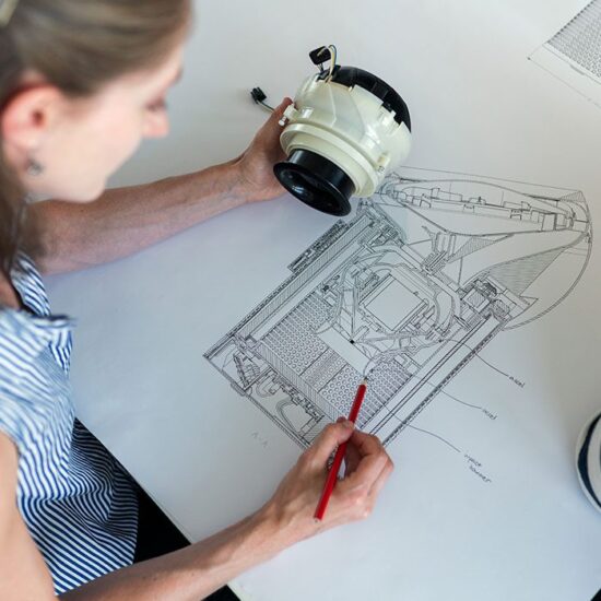 A woman drawing on top of a table.
