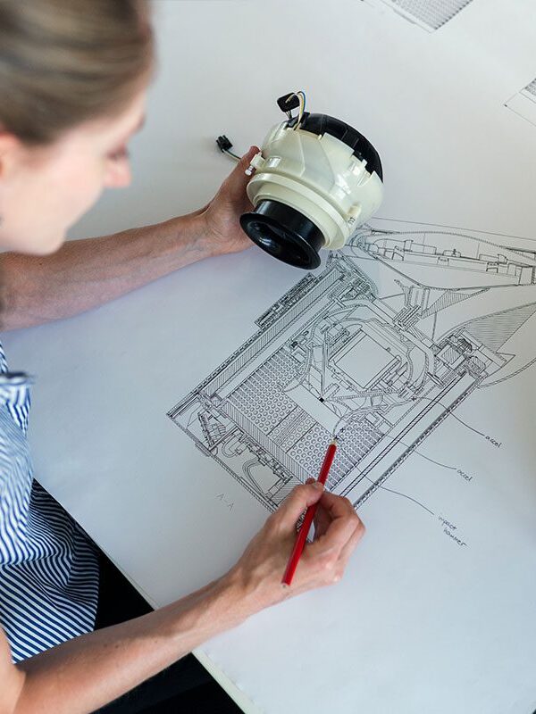 A woman drawing on top of a table.