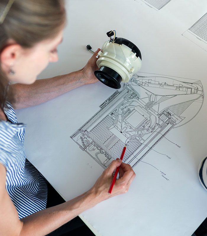 A woman drawing on top of a table.