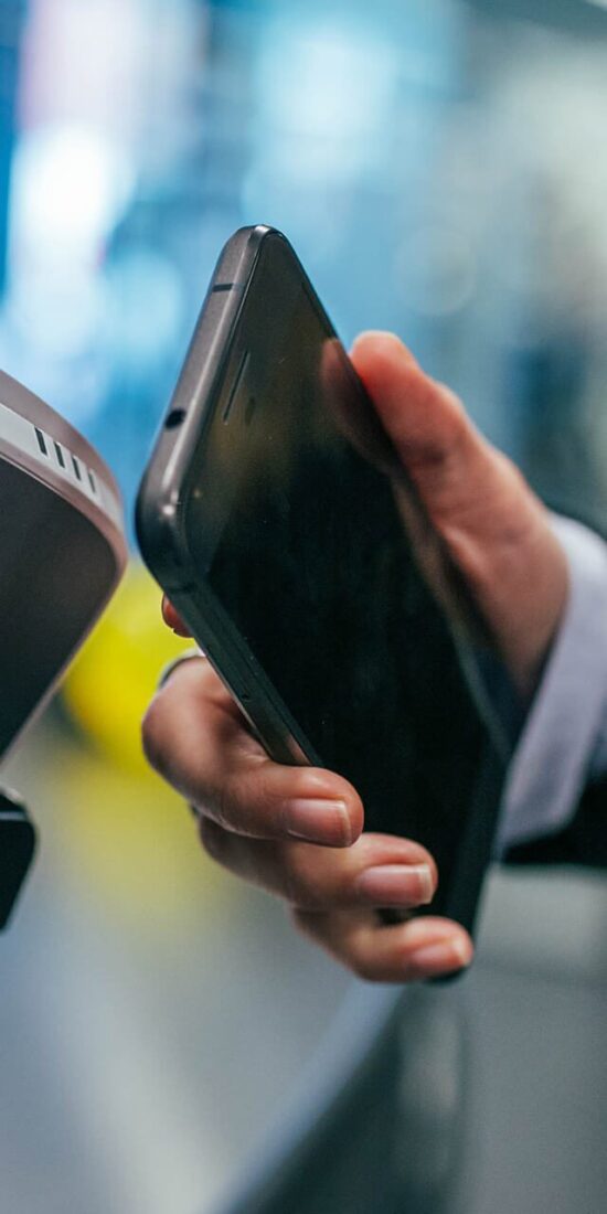 A person holding an iphone in their hand.