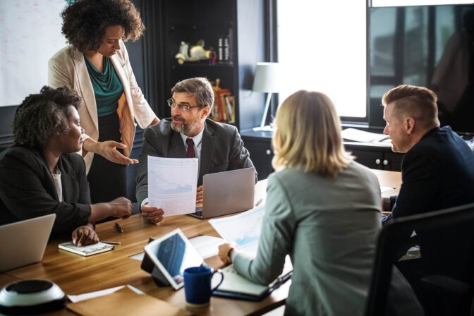 A group of people sitting around a table.