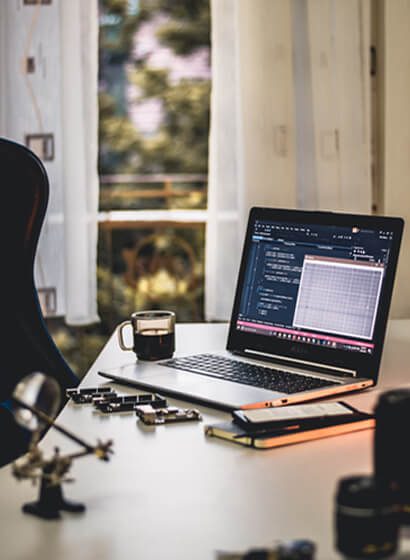 A laptop sitting on top of a desk.